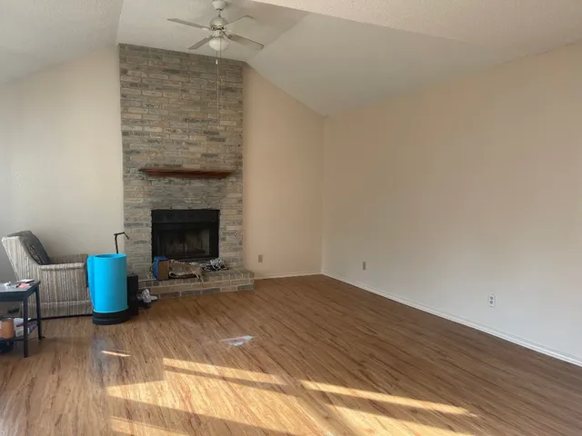 a view of an empty room with a fireplace