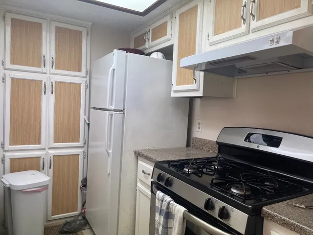 a stove top oven sitting inside of a kitchen