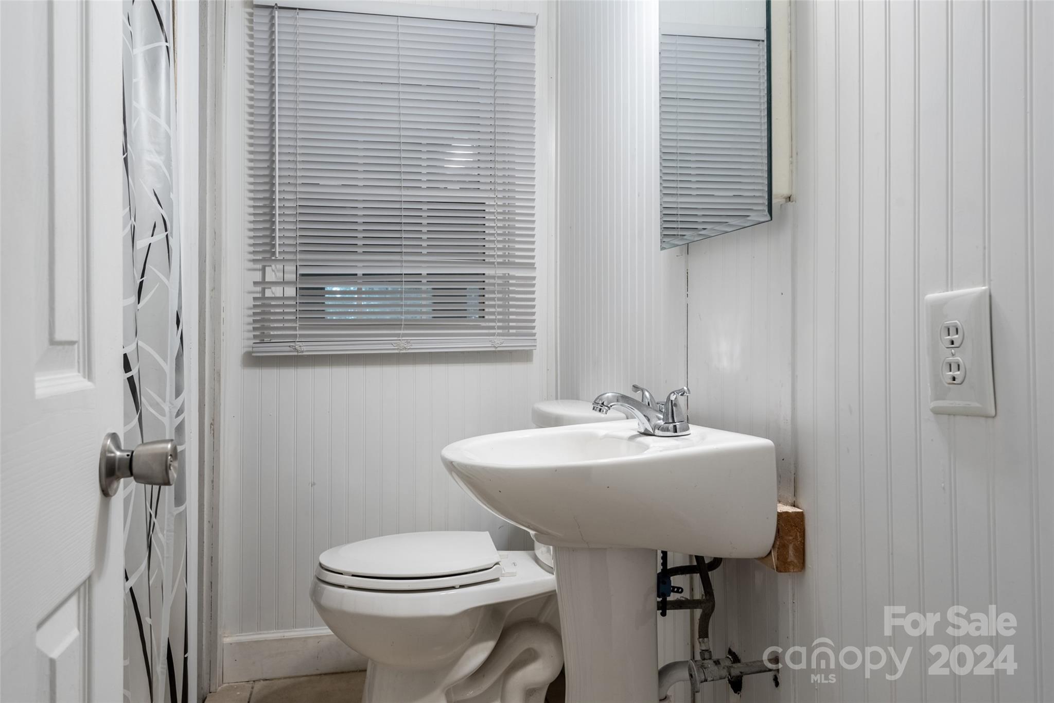 3913 Belk Mill Road Monroe, NC 28112 - Photo 13 of 25 a bathroom with a sink toilet and a mirror