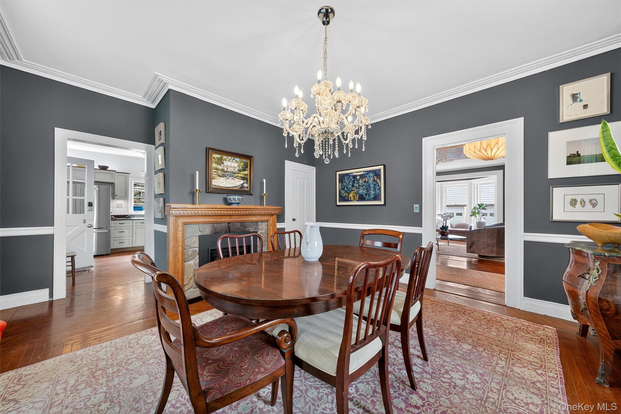 1657 River Road Damascus, PA 18415 - Photo 15 of 43 Dining room with hardwood / wood-style floors, a chandelier, ornamental molding, and a premium fireplace
