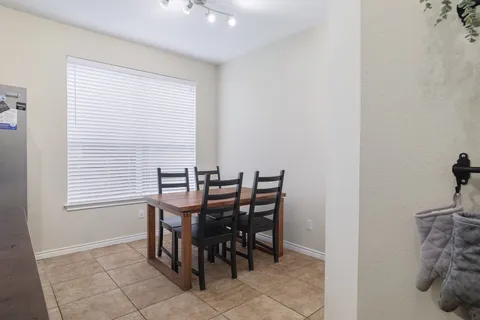 a view of a dining room with furniture and window