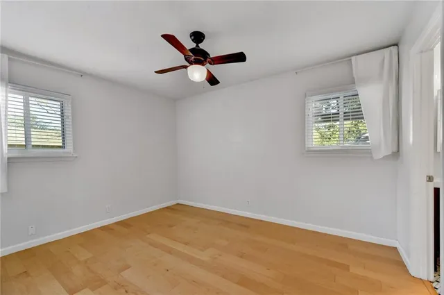 a view of empty room with ceiling fan