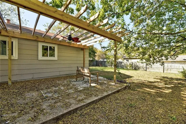 a view of a backyard with a tree