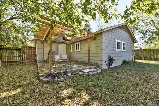 a backyard of a house with barbeque oven