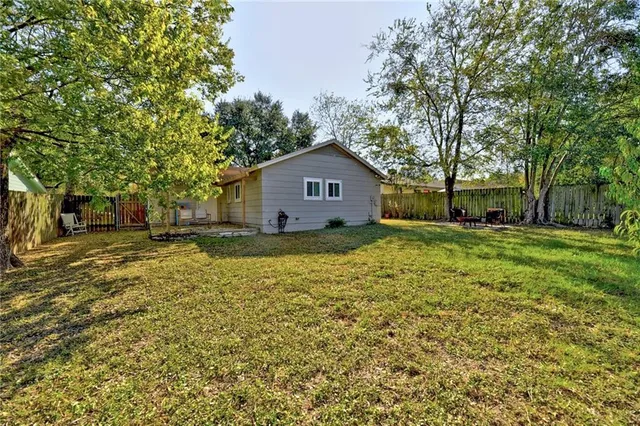 a house with huge green field in front of it