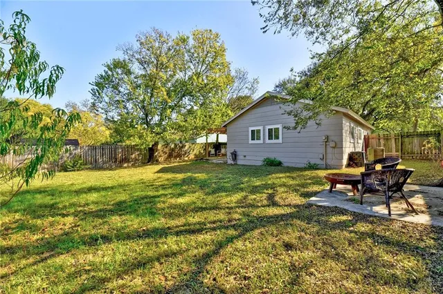 a backyard of a house with table and chairs