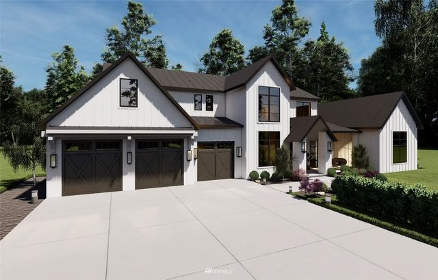a view of a white house with a small yard plants and a large tree