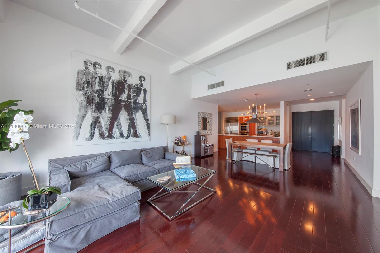 201 Aqua Avenue, Unit 1004 Miami Beach, FL 33141 - Photo 3 of 7 a living room with furniture and wooden floor