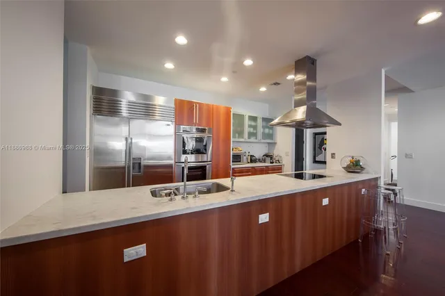a kitchen with stainless steel appliances a sink and a refrigerator