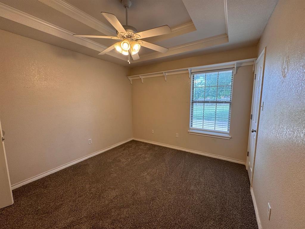 158 Codybug Road Abilene, TX 79602 - Photo 7 of 21 an empty room with a chandelier fan and windows