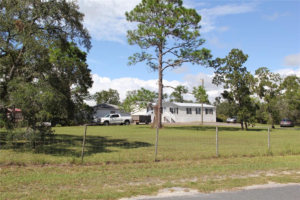 13127 Star Road Brooksville, FL 34613 - Photo 30 of 54 a view of a house with a yard