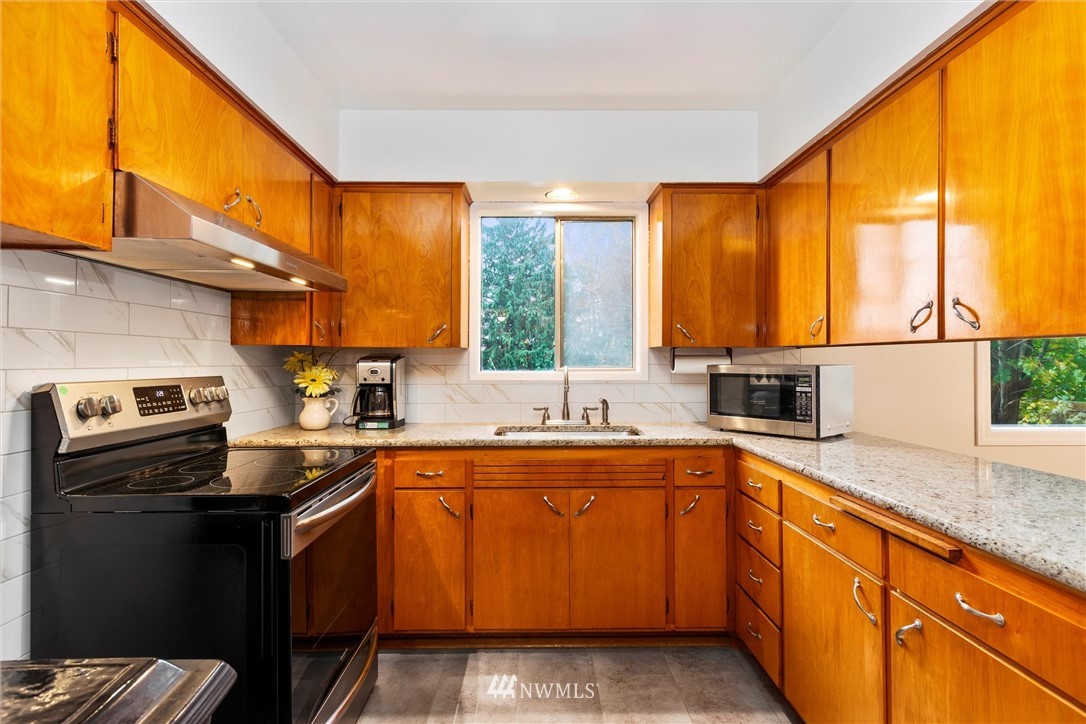 2802 Cavalero Road Lake Stevens, WA 98258 - Photo 14 of 29 a kitchen with stainless steel appliances granite countertop a refrigerator and a sink