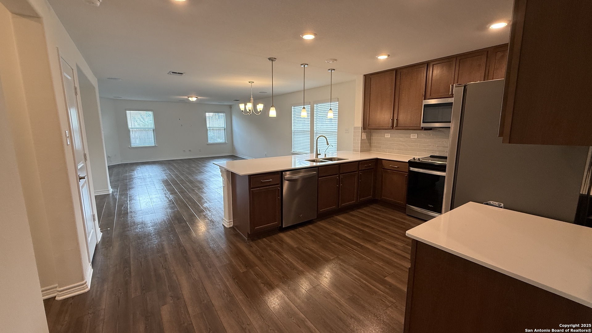 3560 Under Par San Antonio, TX 78245 - Photo 2 of 27 a kitchen with stainless steel appliances granite countertop a sink a stove and refrigerator