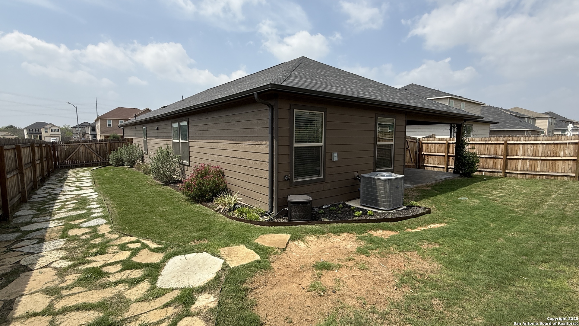 3560 Under Par San Antonio, TX 78245 - Photo 27 of 27 a view of a backyard with plants and a large tree