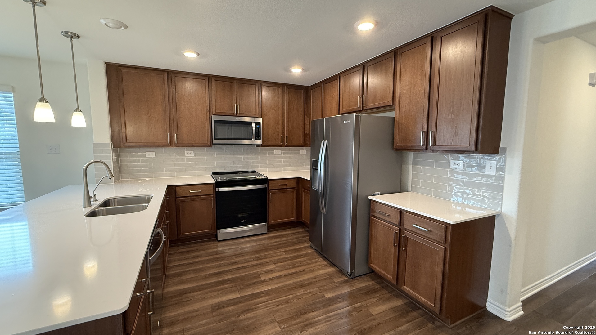 3560 Under Par San Antonio, TX 78245 - Photo 3 of 27 a kitchen with granite countertop stainless steel appliances and wooden cabinets
