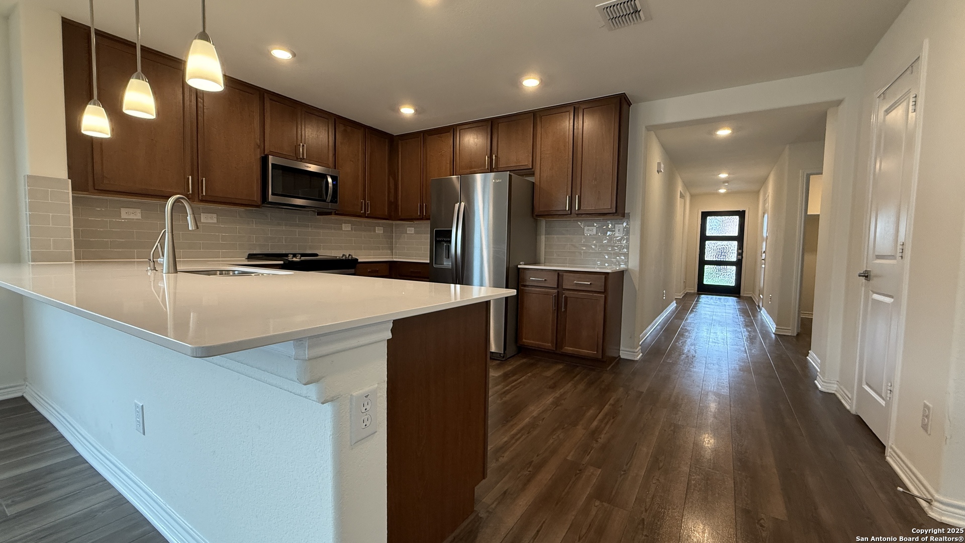 3560 Under Par San Antonio, TX 78245 - Photo 4 of 27 a kitchen with counter top space cabinets and stainless steel appliances
