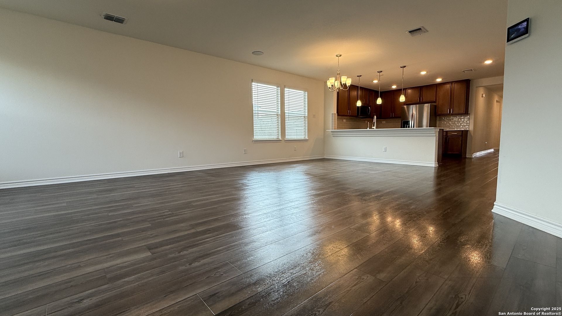 3560 Under Par San Antonio, TX 78245 - Photo 8 of 27 an empty room with wooden floor and windows