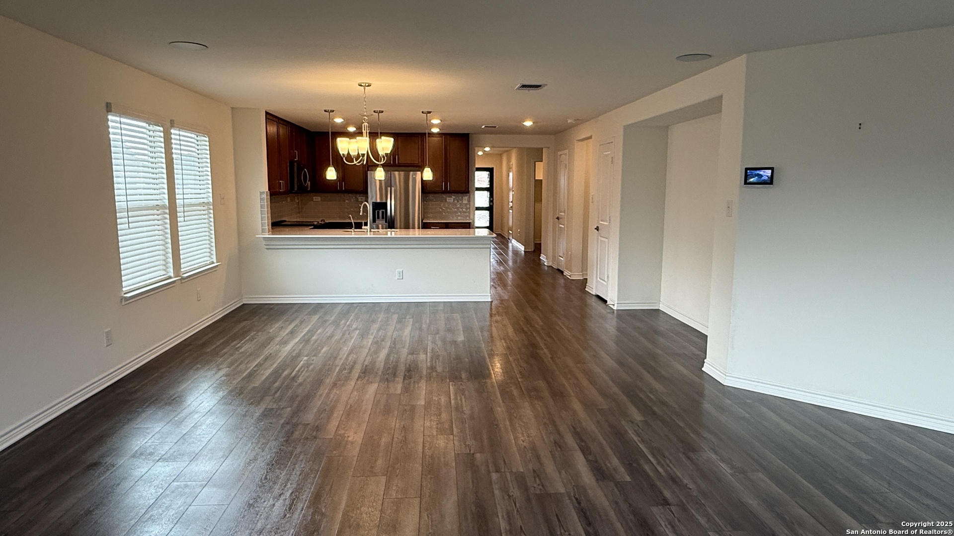 3560 Under Par San Antonio, TX 78245 - Photo 9 of 27 wooden floor in an empty room with a window