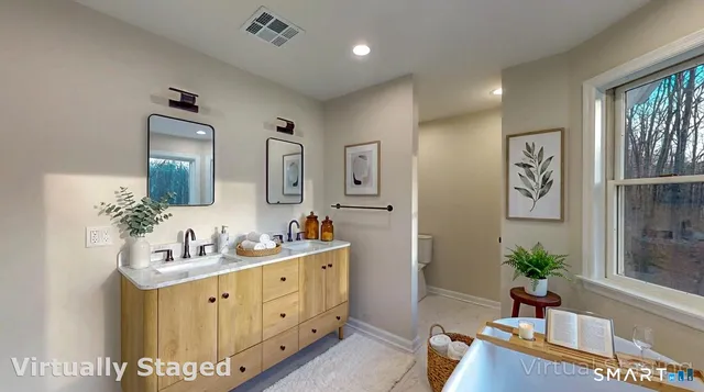 a bathroom with a double vanity sink and a mirror