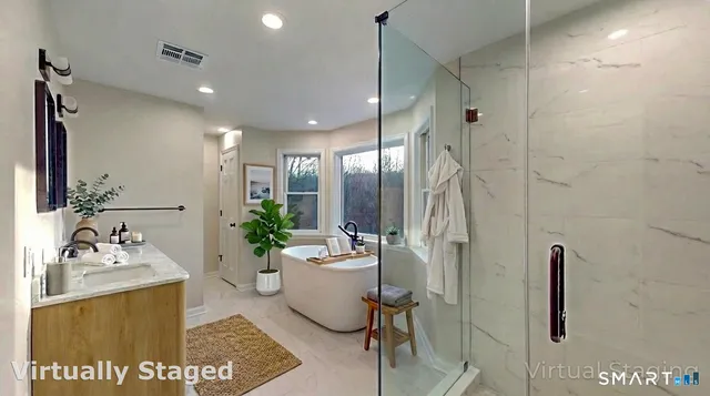 a spacious bathroom with a double vanity sink a mirror and shower