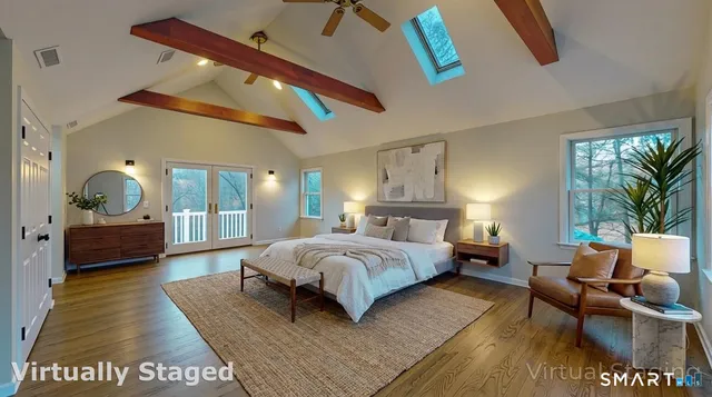 a spacious bedroom with a bed a couch and dresser in it