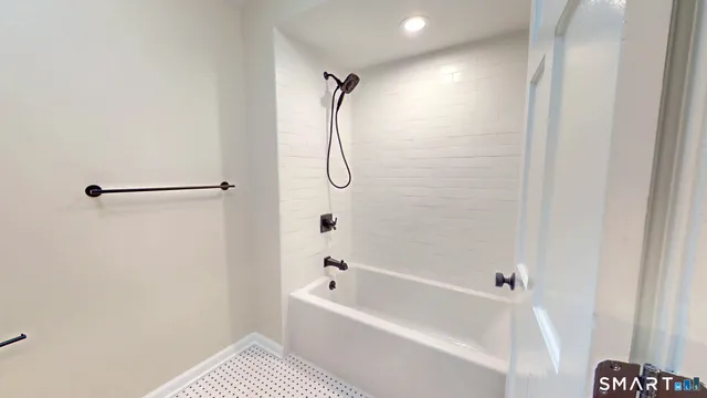 a bathroom with a bathtub and a shower