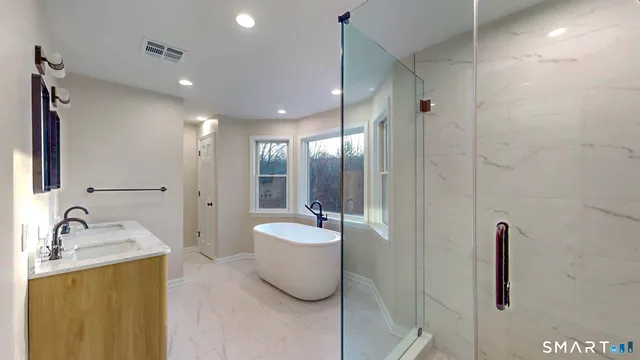 a bathroom with a double vanity sink and a mirror