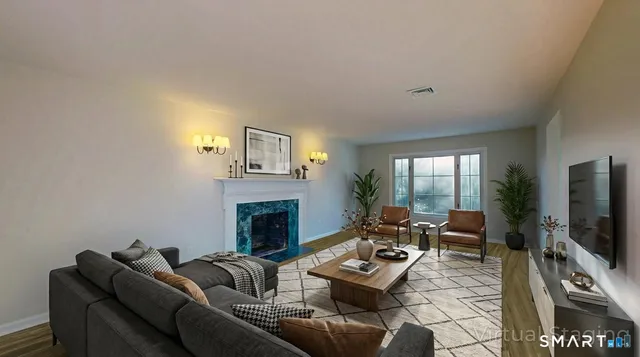 a living room with furniture flat screen tv and a fireplace