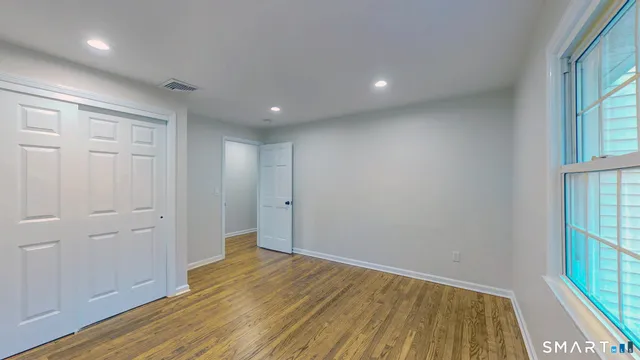 wooden floor in an empty room with a window