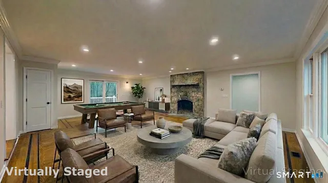 a living room with furniture and a fireplace