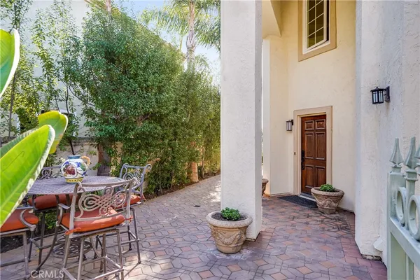 a backyard of a house with barbeque oven table and chairs