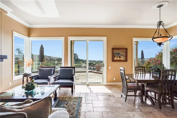 a living room with fireplace furniture and a floor to ceiling window