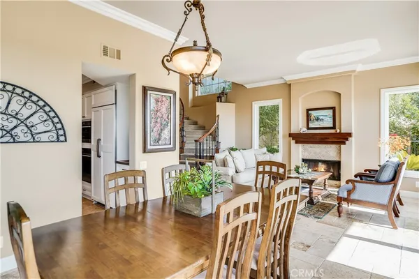 a view of a dining room with furniture a chandelier and wooden floor