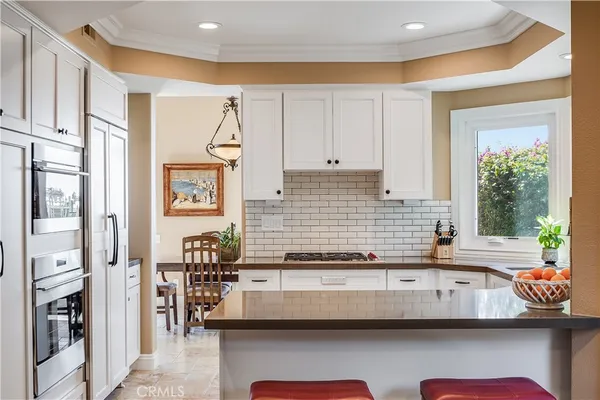 a kitchen with granite countertop a sink and a stove