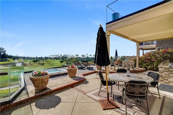 a view of swimming pool with outdoor seating and a patio