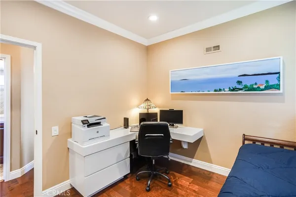 a view of a workspace with furniture and a window
