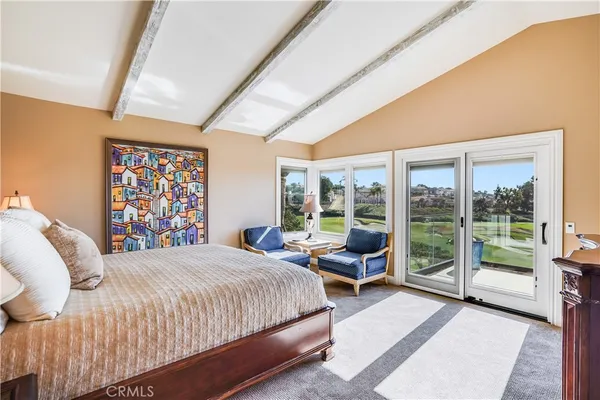 a bedroom with a large bed and a large window