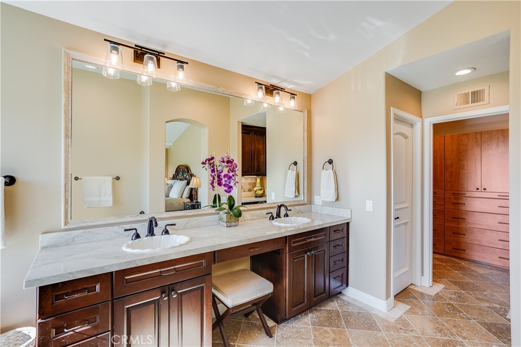 6 Marquesa Dana Point, CA 92629 - Photo 45 of 46 a bathroom with a granite countertop sink a mirror and a shower