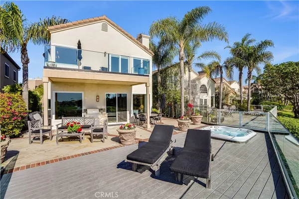 a view of a patio with couches table and chairs potted plants and palm tree
