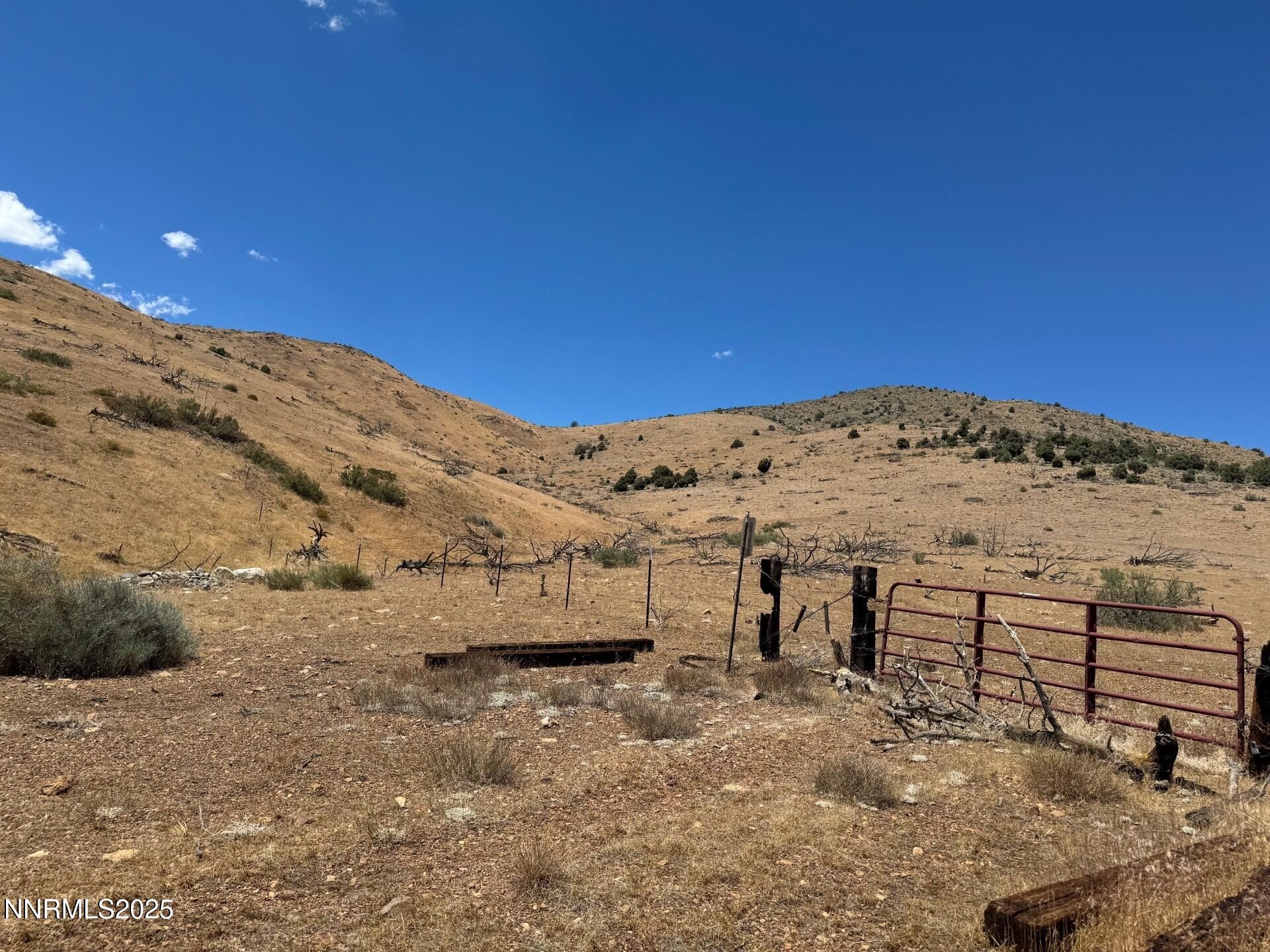 1400 Breccia Road Wellington, NV 89444 - Photo 4 of 14 a view of large stone house and mountain view