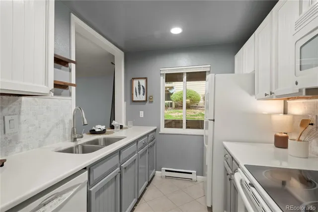 a kitchen that has a sink and a stove