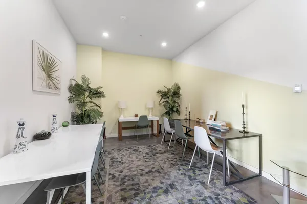 a dining room with furniture and wooden floor