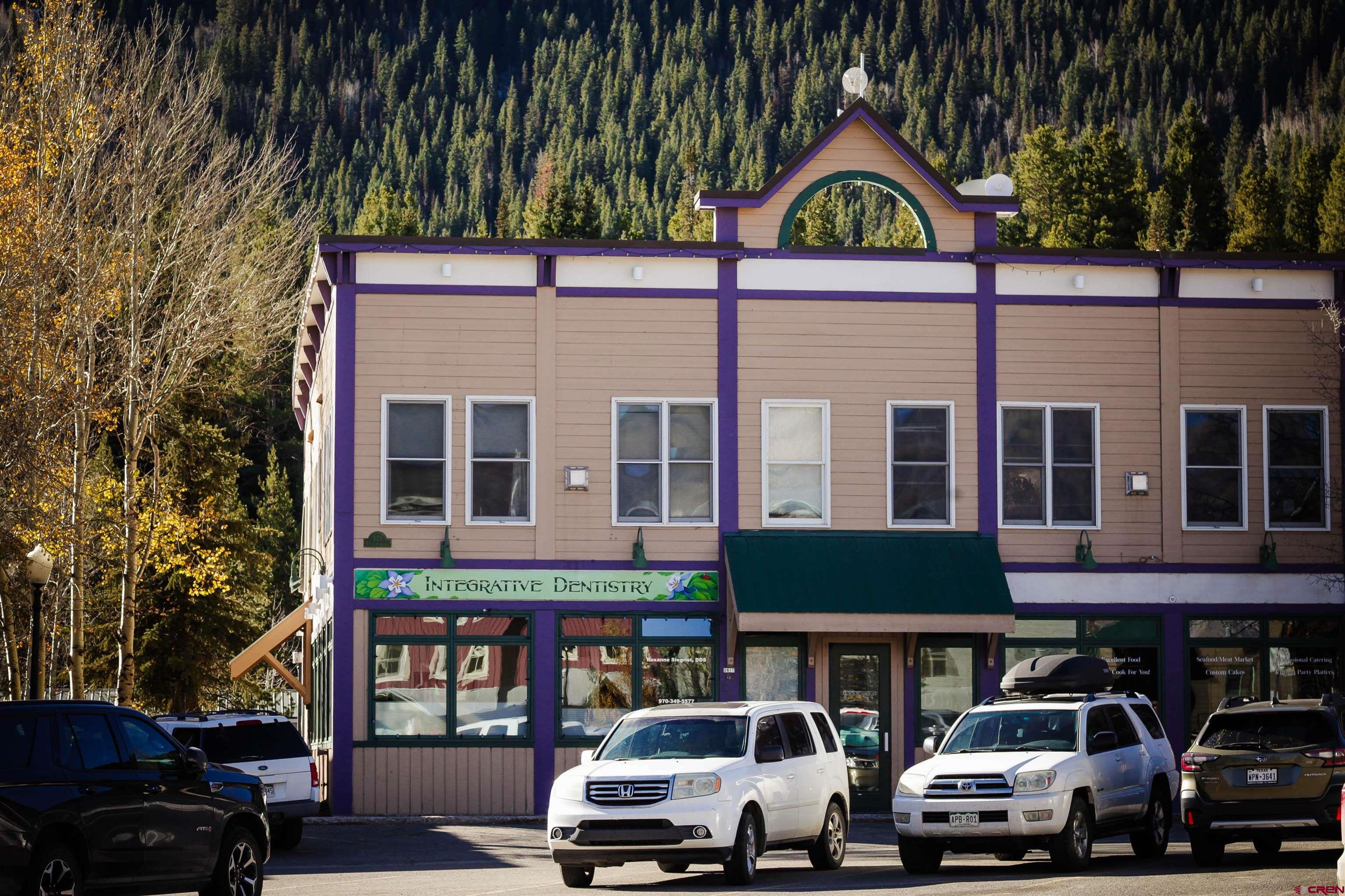 525 Red Lady Avenue, Unit 241 246 Crested Butte, CO 81224 - Photo 3 of 17 a front view of a residential apartment building with a yard