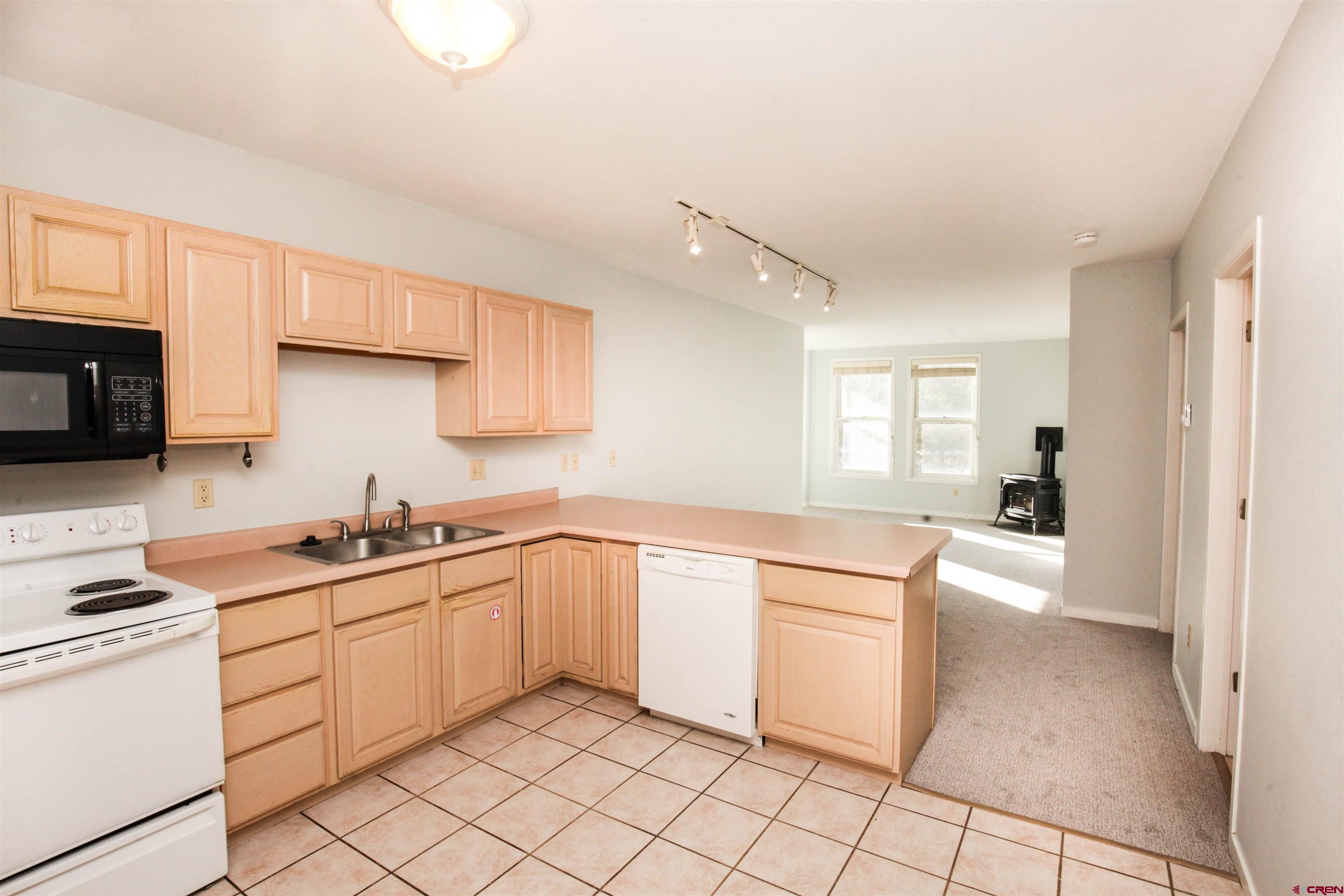 525 Red Lady Avenue, Unit 241 246 Crested Butte, CO 81224 - Photo 10 of 17 a kitchen with white cabinets appliances and a window