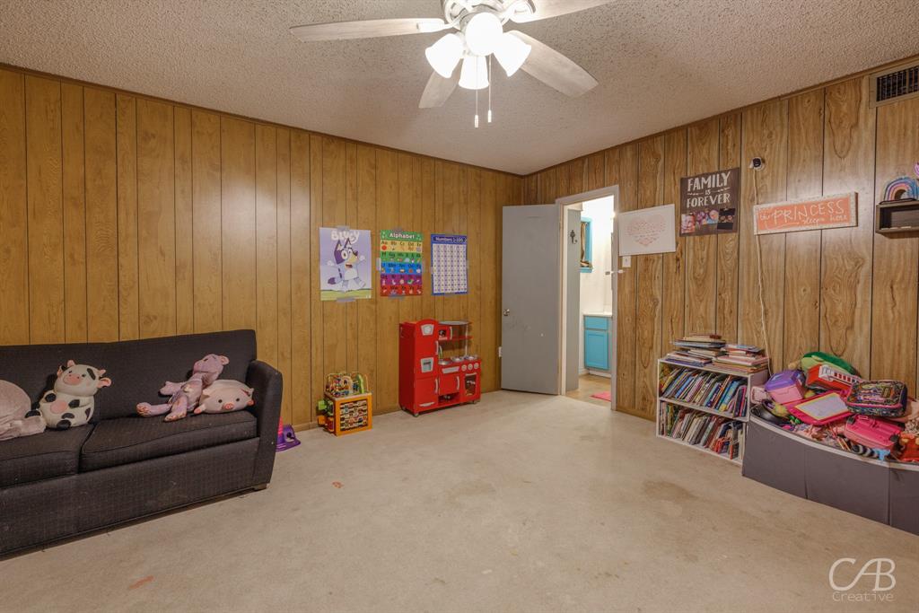 33 Northwest Ave A Hamlin, TX 79520 - Photo 23 of 37 a living room with furniture and a chandelier