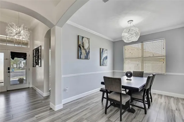a bedroom with a large bed and a chandelier