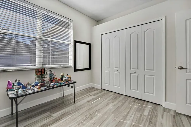 a bedroom with a bed closet and a window