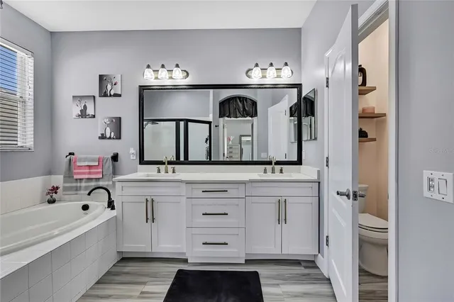 a view of a backyard with wooden floor and iron fence