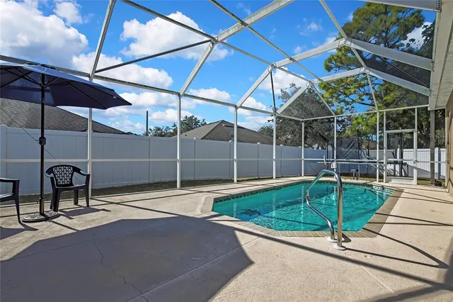 a view of a chair and table in backyard