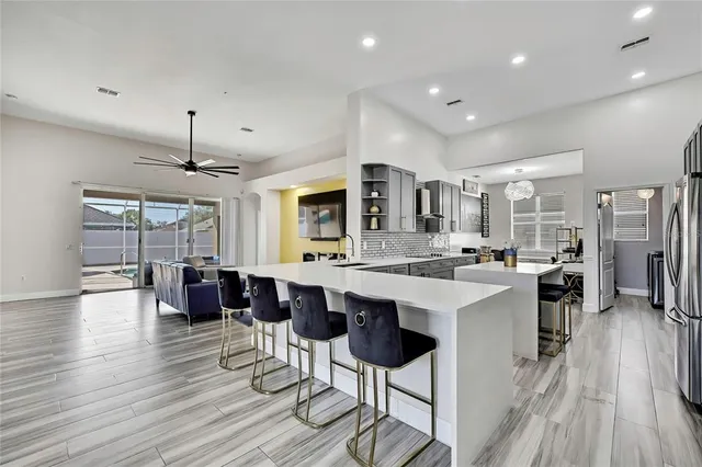 a kitchen with stainless steel appliances a refrigerator sink and cabinets